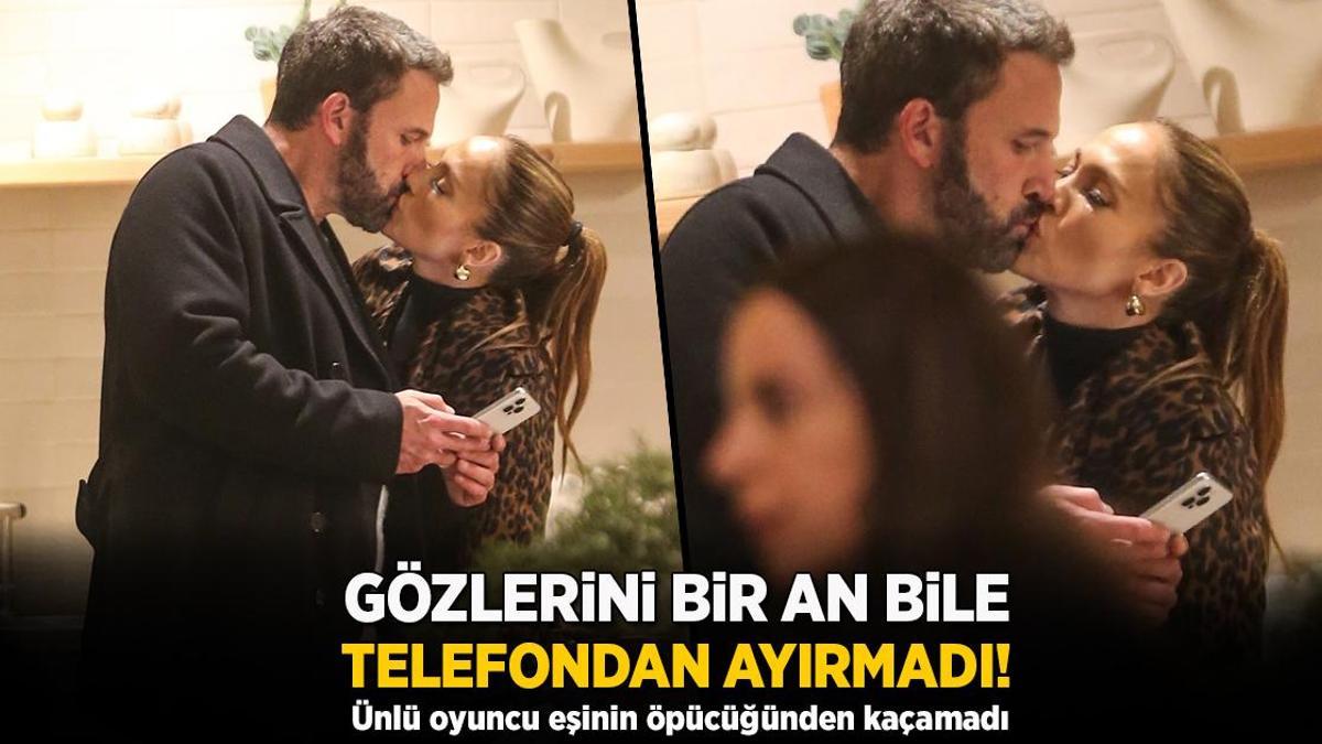 Eşinin öpücüğünden kaçamadı! Gözlerini telefonundan bir an olsun ayırmadı